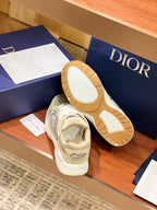 Beige sneakers with visible tan outsoles and side emblem details