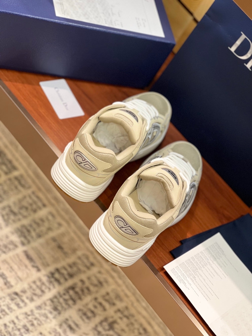 Beige lace-up sneakers from heel view with textured rubber sole