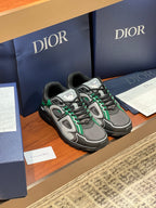 Dior ladies sneakers side view, grey upper with green trim and black outsole
