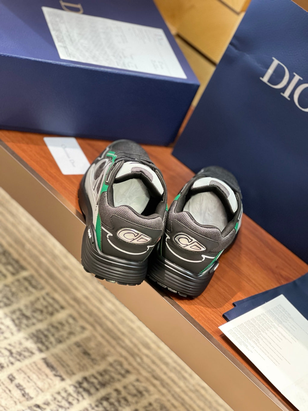 Dior ladies sneakers heel view, grey upper with green laces and thick tread