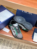 Dior ladies sneakers with outsole visible, grey uppers and green lace accents
