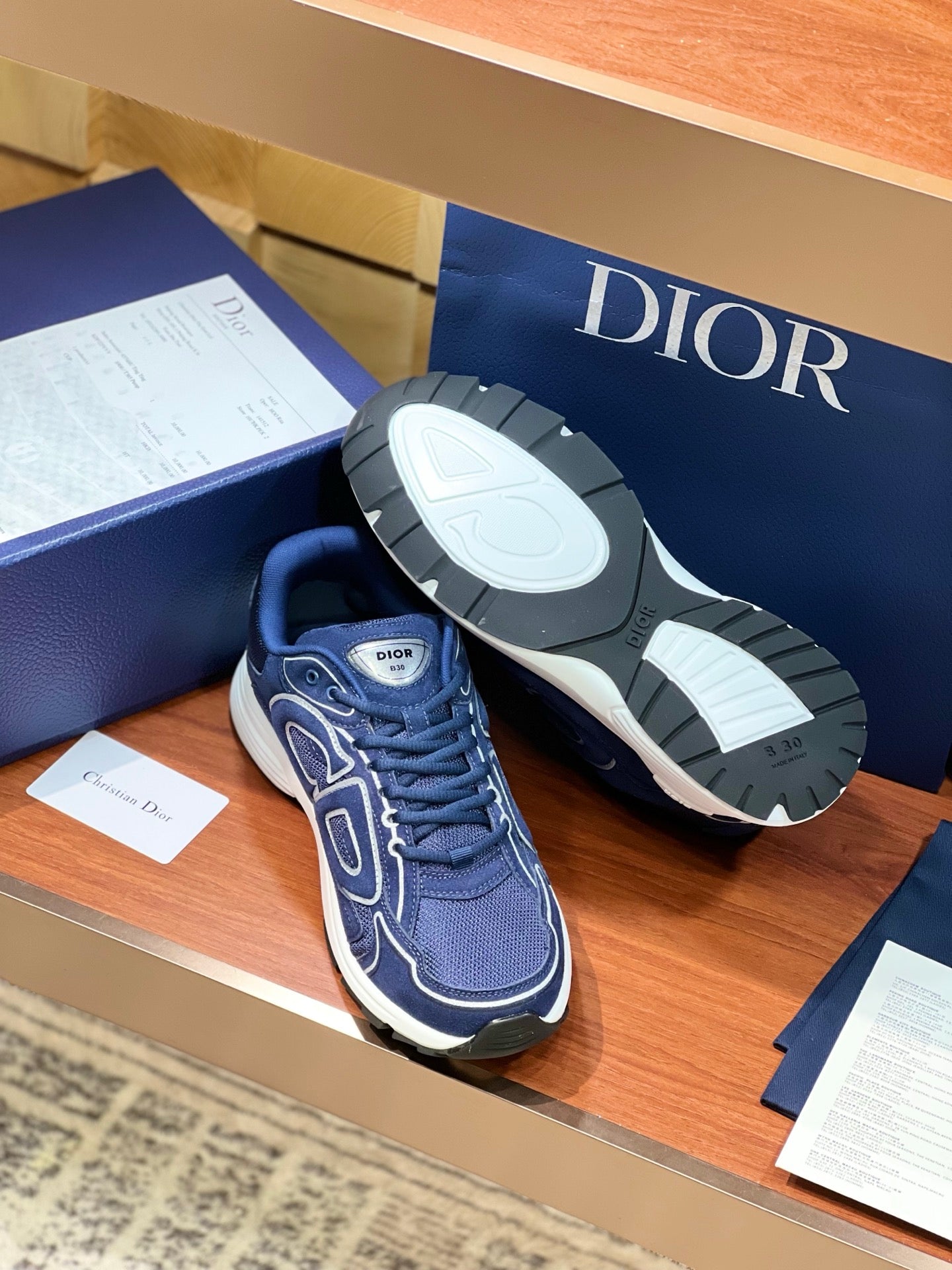 Navy Dior lace-up sneakers with white rubber outsole and logo side detailing