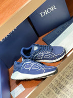 Navy Dior lace-up sneakers with white midsoles and large side logo print, side view