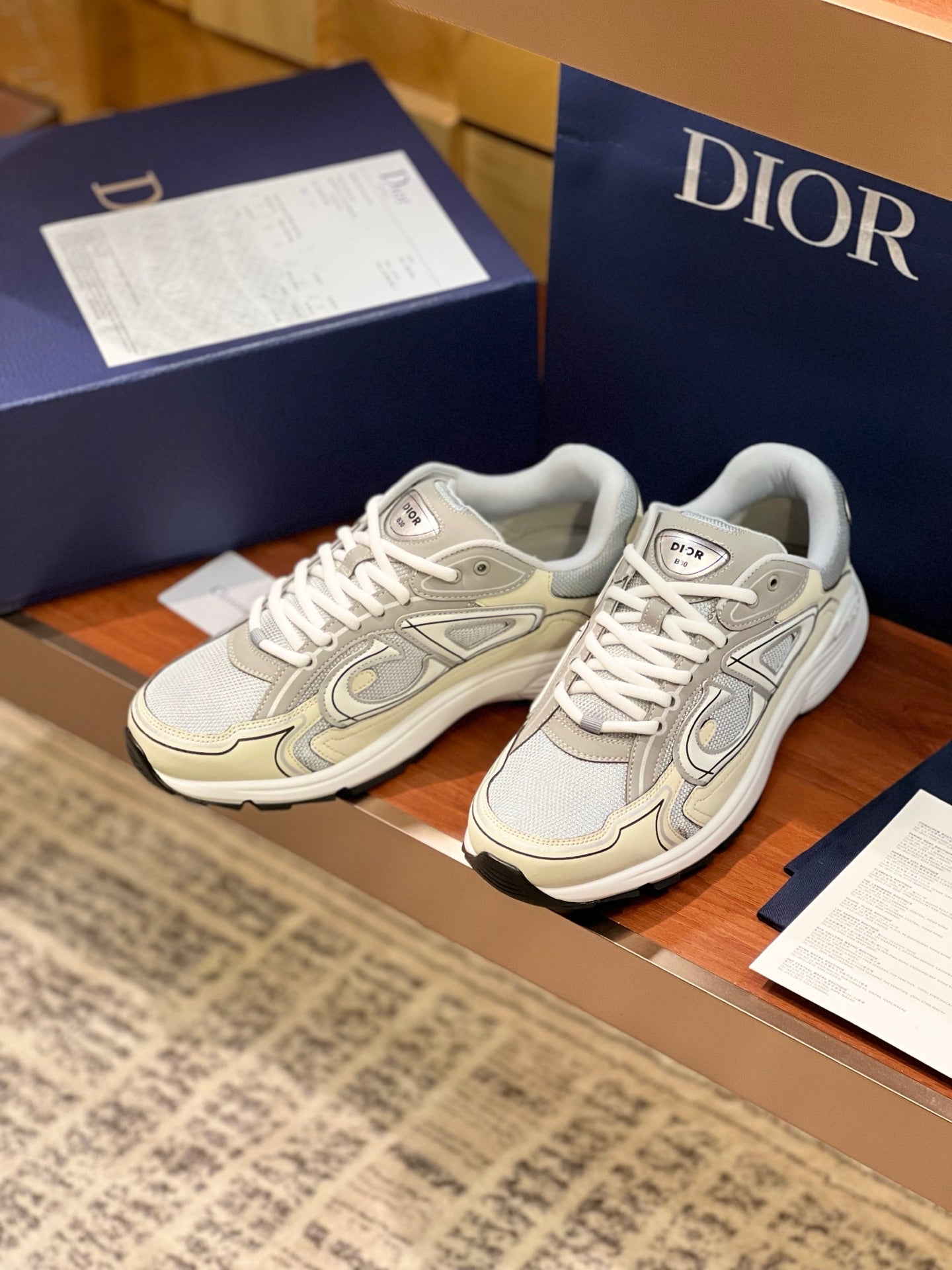 Ladies lace-up sneakers in light beige and grey with bold side emblem detail