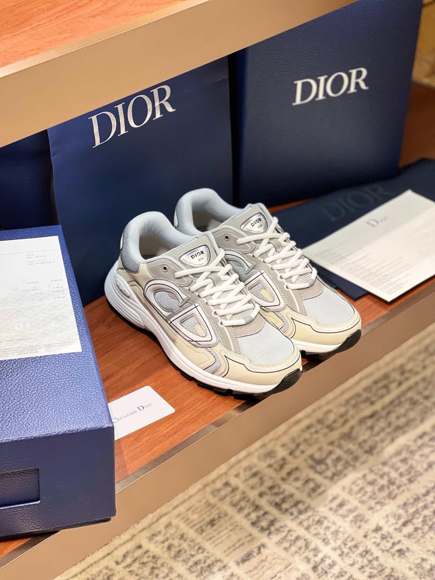 Pair of ladies lace-up sneakers in light beige and grey with textured rubber sole