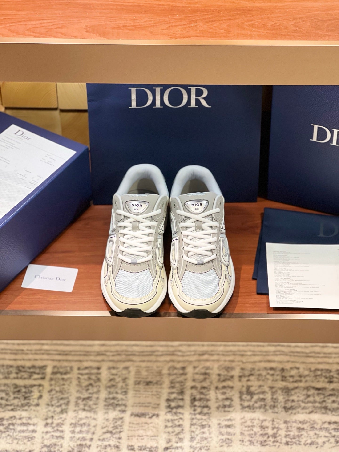 Ladies lace-up sneakers in light beige and grey with Dior logo accents