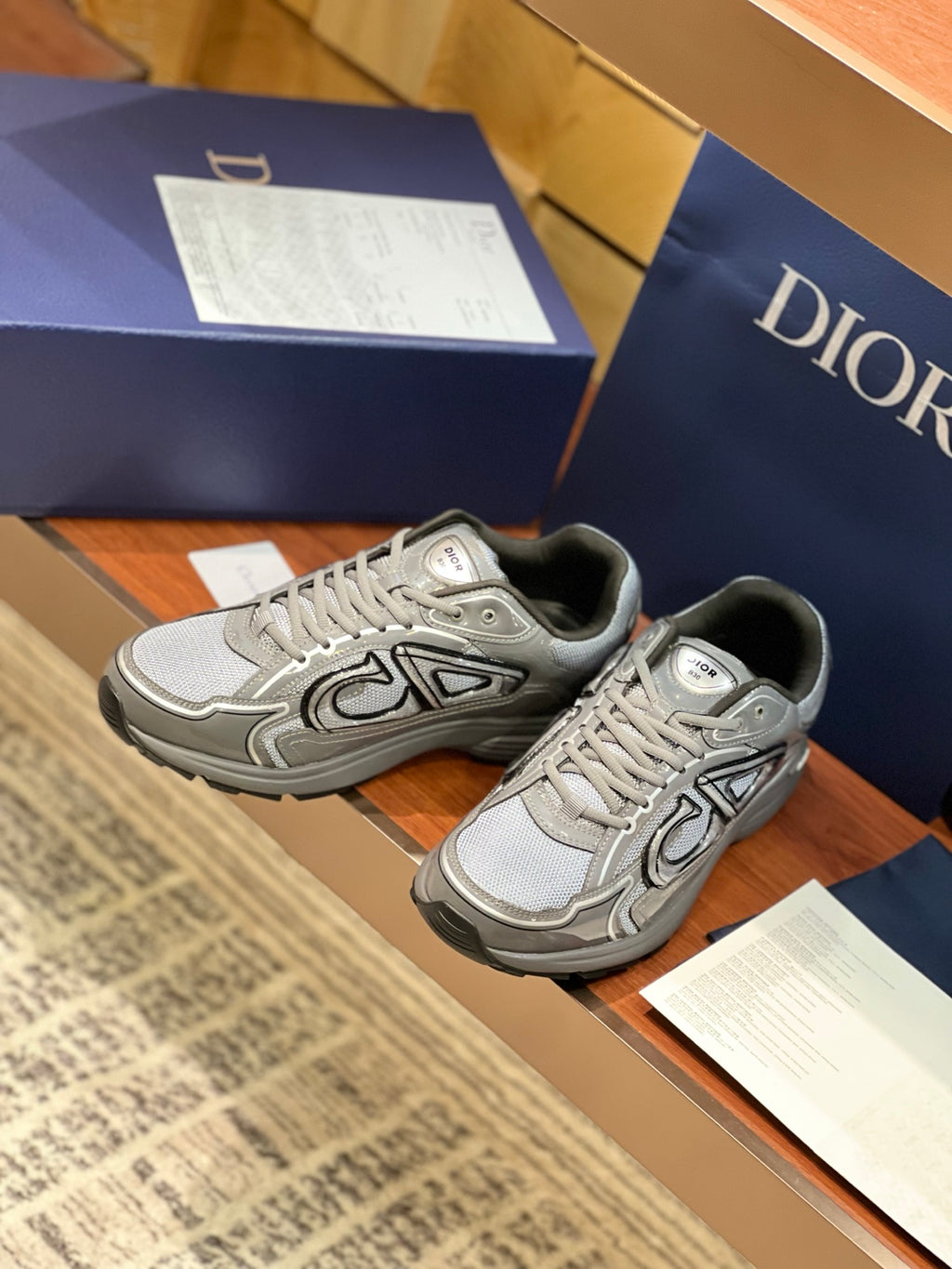 Dior ladies grey lace-up sneakers, front angled view with decorative panels
