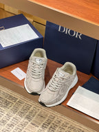 Dior women's beige lace-up sneakers, angled view with two shoes shown