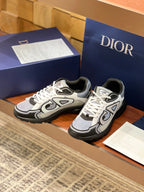 Dior low-top lace-up sneakers, gray and black colorblock with oversized logo overlays