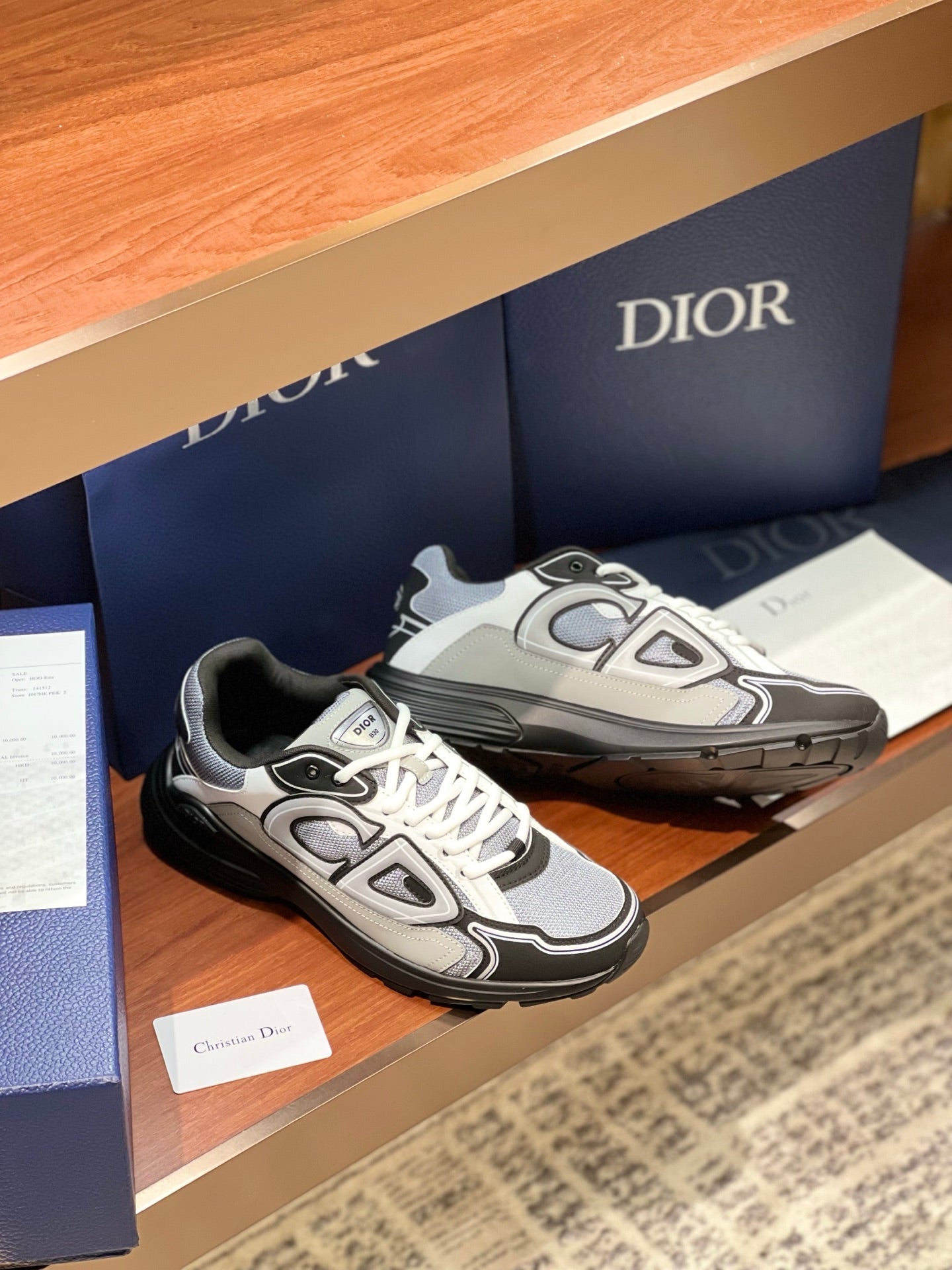 Dior low-top lace-up sneakers, white laces and gray uppers with black outsole trim