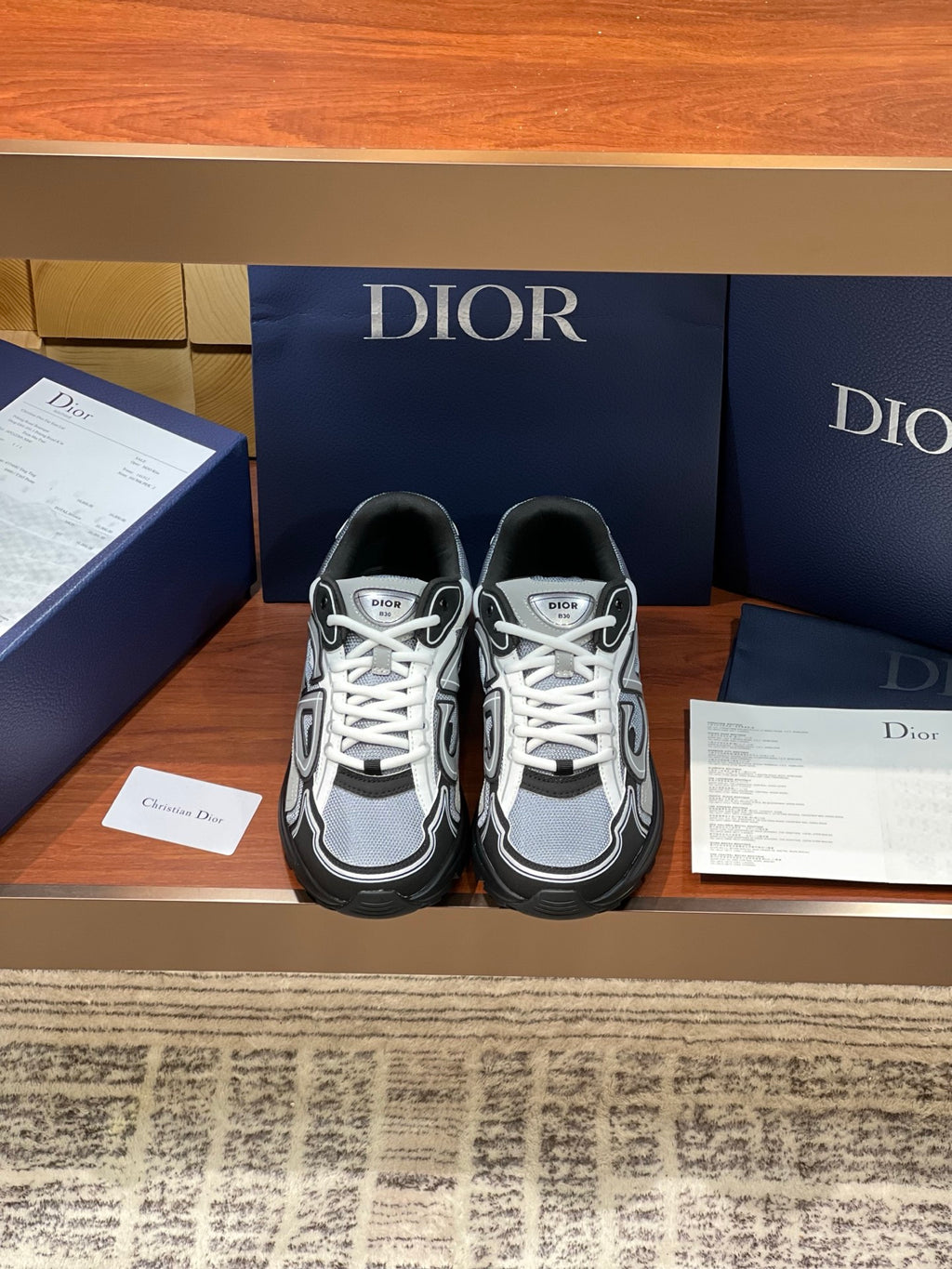 Dior low-top lace-up sneakers, white laces, gray and black panels with logo accents