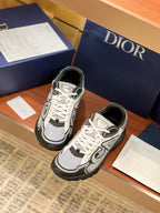 Dior low-top lace-up sneakers, front and side views, gray and black with white logo detail