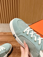 Hermes unisex light blue suede sneaker close-up, white laces and rubber sole