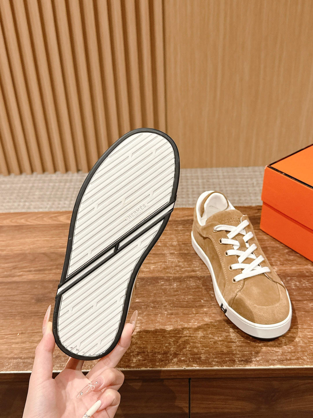 Tan suede low-top sneaker with white treaded outsole and white laces