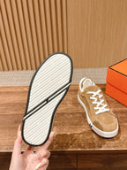 Tan suede low-top sneaker with white treaded outsole and white laces