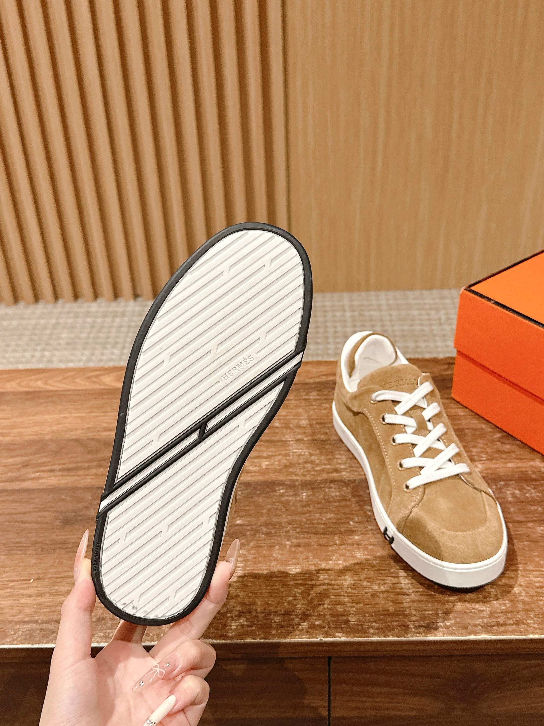 Tan suede low-top sneaker with white treaded outsole and white laces