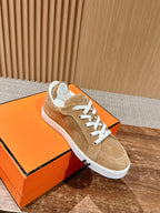 Tan suede low-top sneakers with white laces and white edge sole