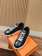 Hermes unisex black leather low-top sneakers with white laces and white rubber soles