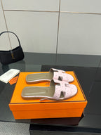 Ladies light pink leather slide sandals with adjustable wide straps and padded taupe footbed