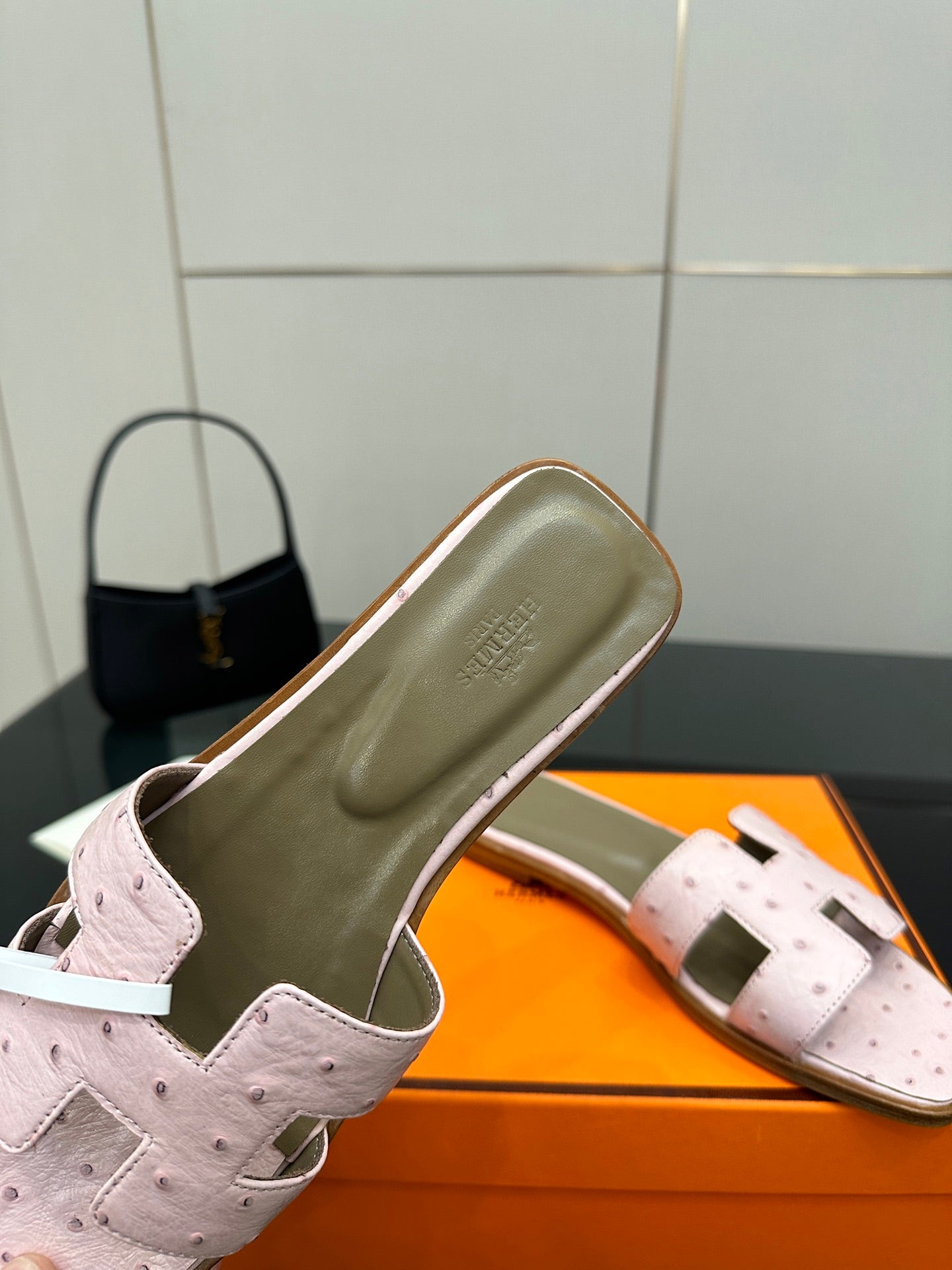 Ladies light pink leather slide sandals, close-up of strap with taupe interior lining