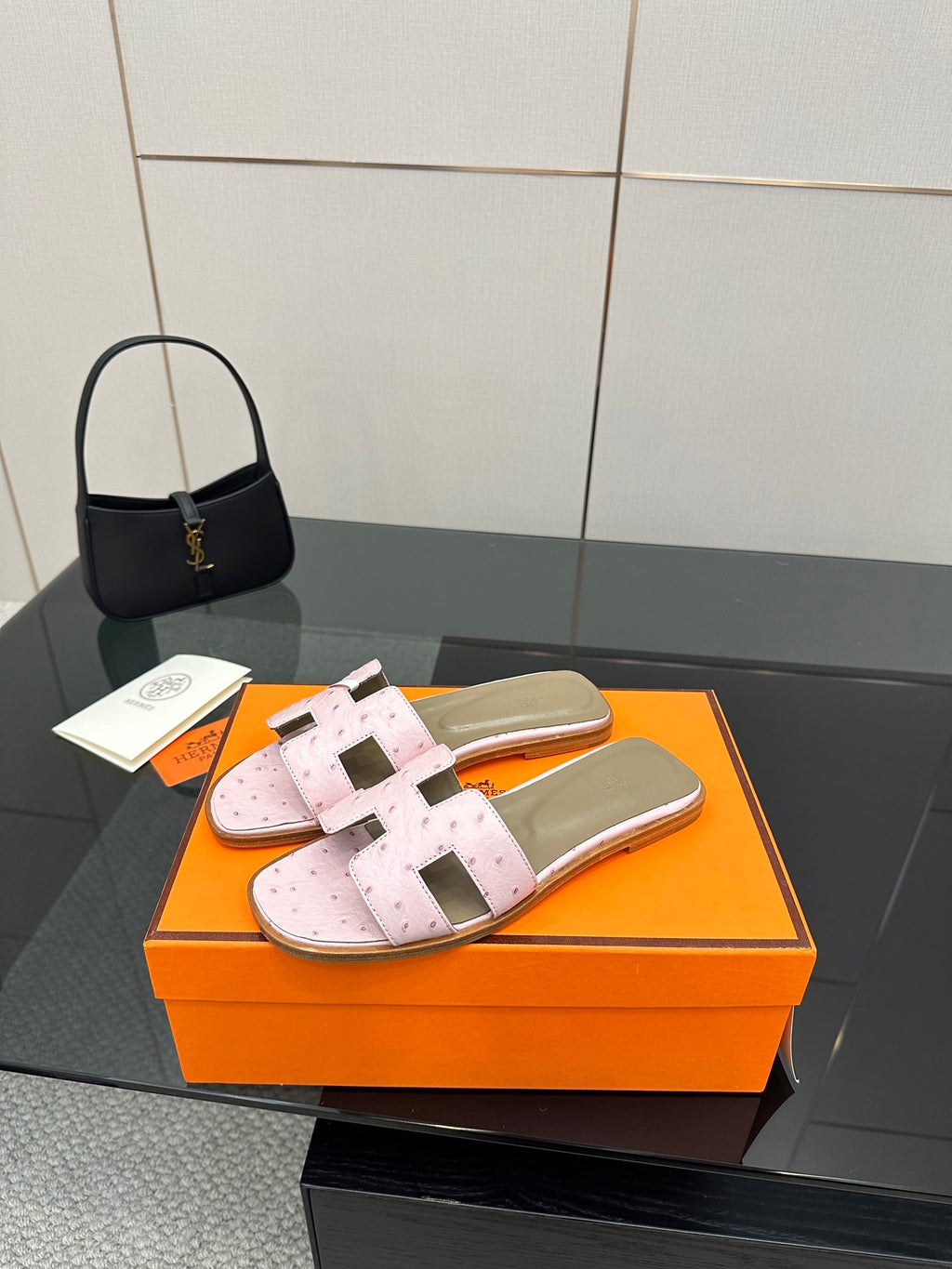 Ladies light pink leather slide sandals with wide straps and buckle-style hardware