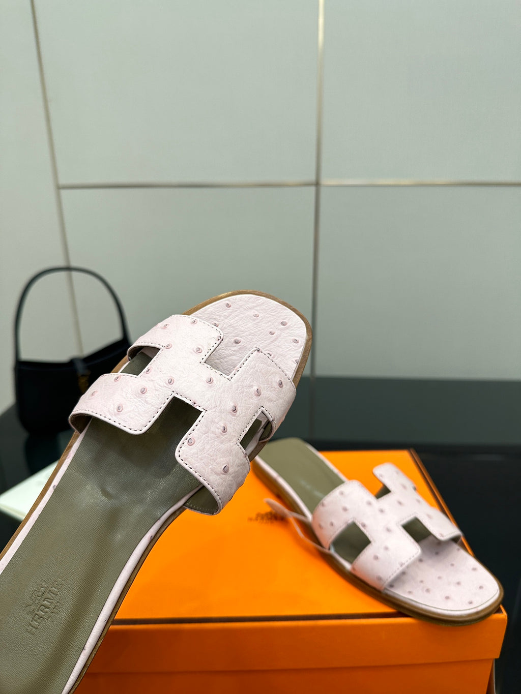 Ladies light pink leather slide sandals with perforated upper and wide strap over instep