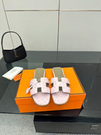 Ladies light pink leather slide sandals with perforated footbed and two strap closures
