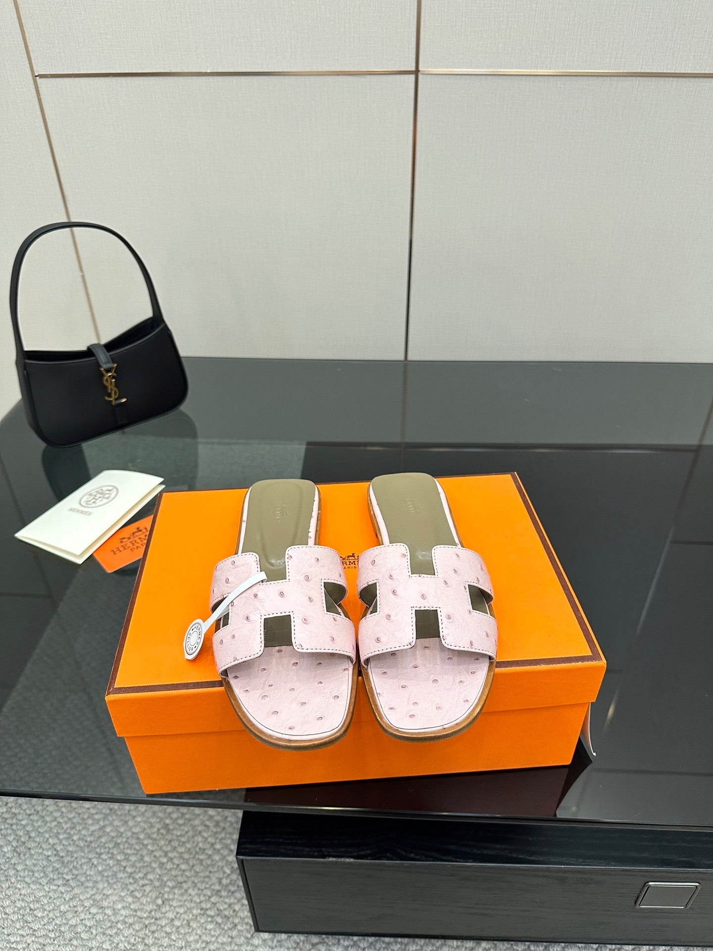 Ladies light pink leather slide sandals with perforated footbed and two strap closures