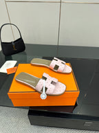 Ladies light pink leather slide sandals with two wide straps and taupe cushioned lining