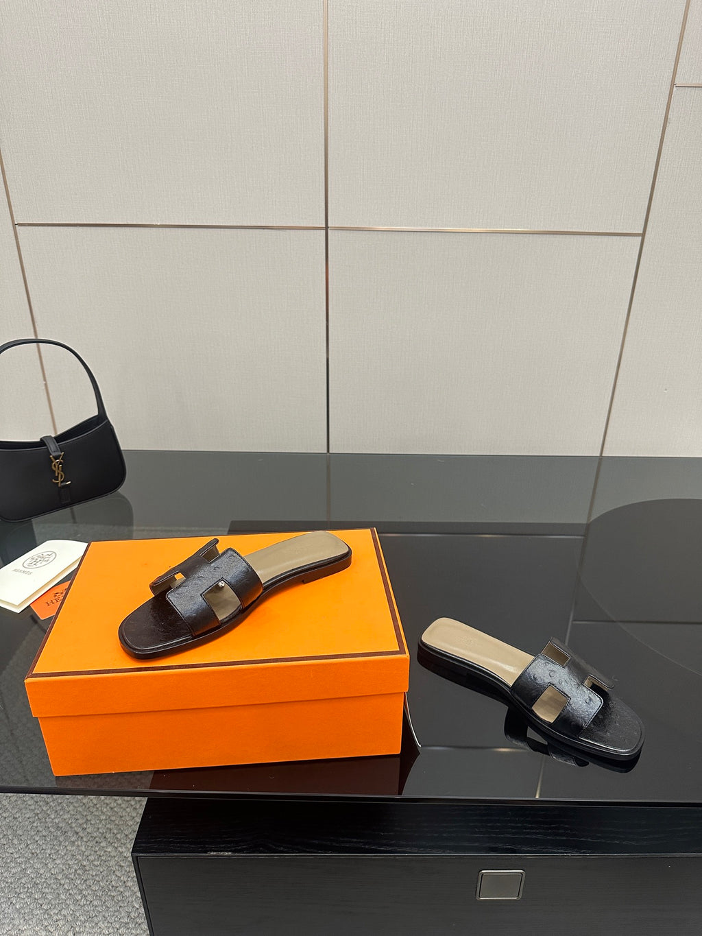 Black leather slide sandals with wide strap, cream footbed, low heel