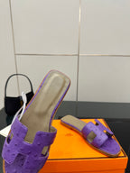 Hermes purple slide sandals, close side view with footbed and cutout strap