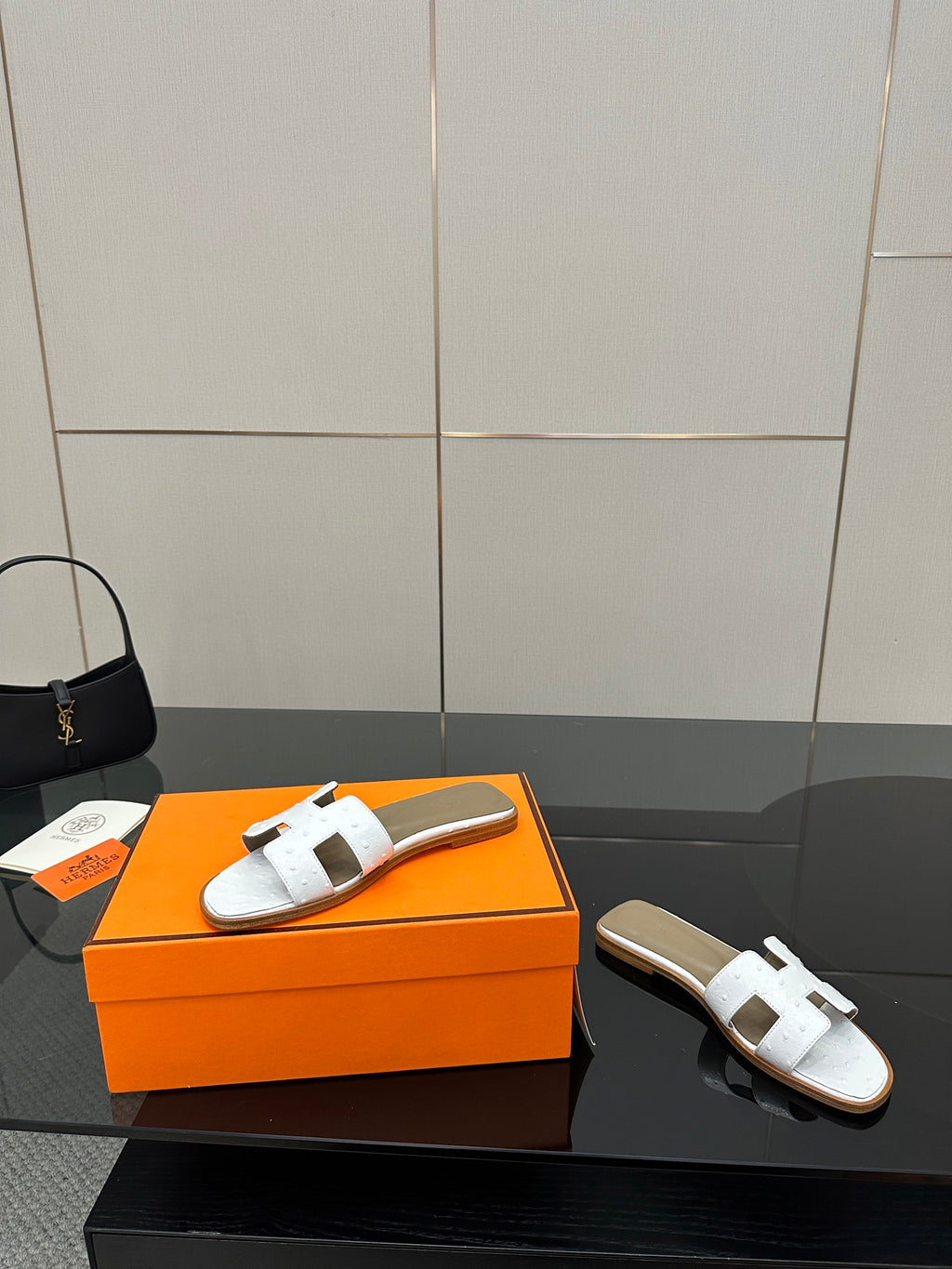White leather slide sandals with two wide straps and open toe