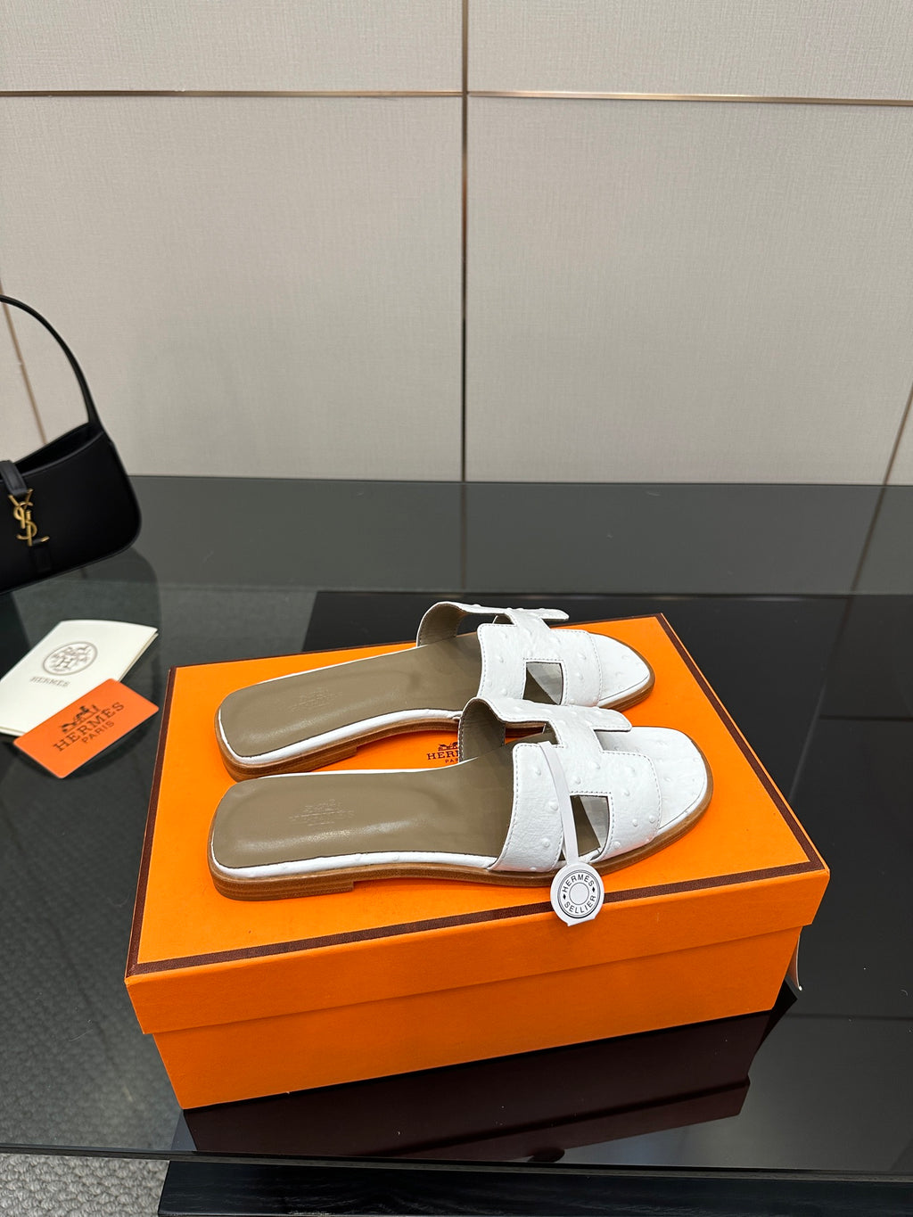 White leather slide sandals with two straps and textured upper, open toe