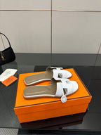 White leather slide sandals with two straps and textured upper, open toe