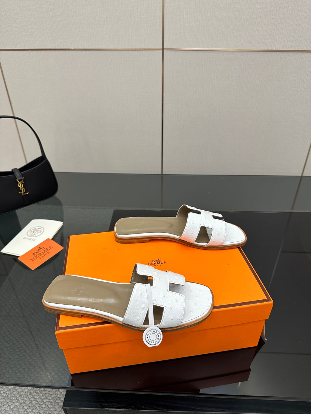 White leather slide sandal pair with two-panel straps and open toe