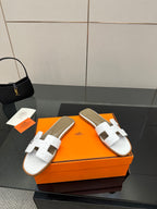 White leather slide sandals with double wide straps and open toe
