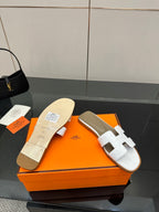 White leather slide sandal with two straps and light-colored footbed