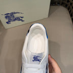 Burberry white sneaker with blue-trimmed collar and logo on tongue