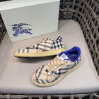 Sneakers with beige-and-navy check canvas, blue inner lining, and lace-up front