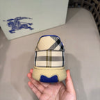 Sneaker heel view with beige check pattern and blue textured outsole detail