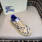 Single sneaker with blue collar, beige laces, and check-pattern upper