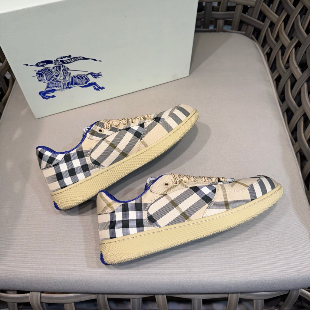 Matching set of low-top sneakers with beige base, navy check, and blue accents