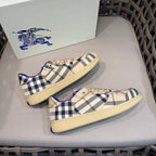 Matching set of low-top sneakers with beige base, navy check, and blue accents