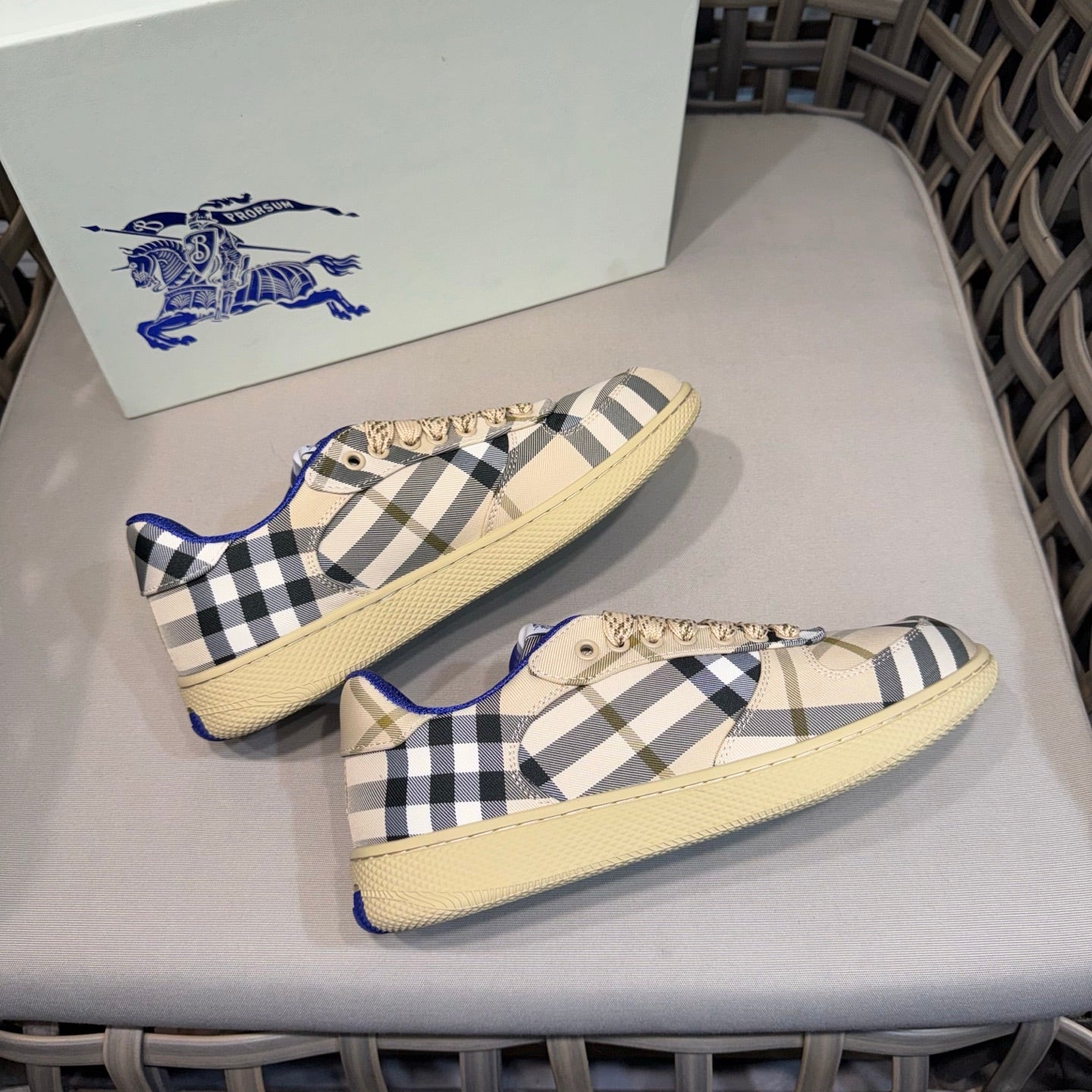 Matching set of low-top sneakers with beige base, navy check, and blue accents
