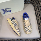 Pair of sneakers with blue heel collar and beige-and-navy check side panels