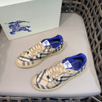Low-top sneakers with navy-and-white check uppers, beige laces, and blue trim