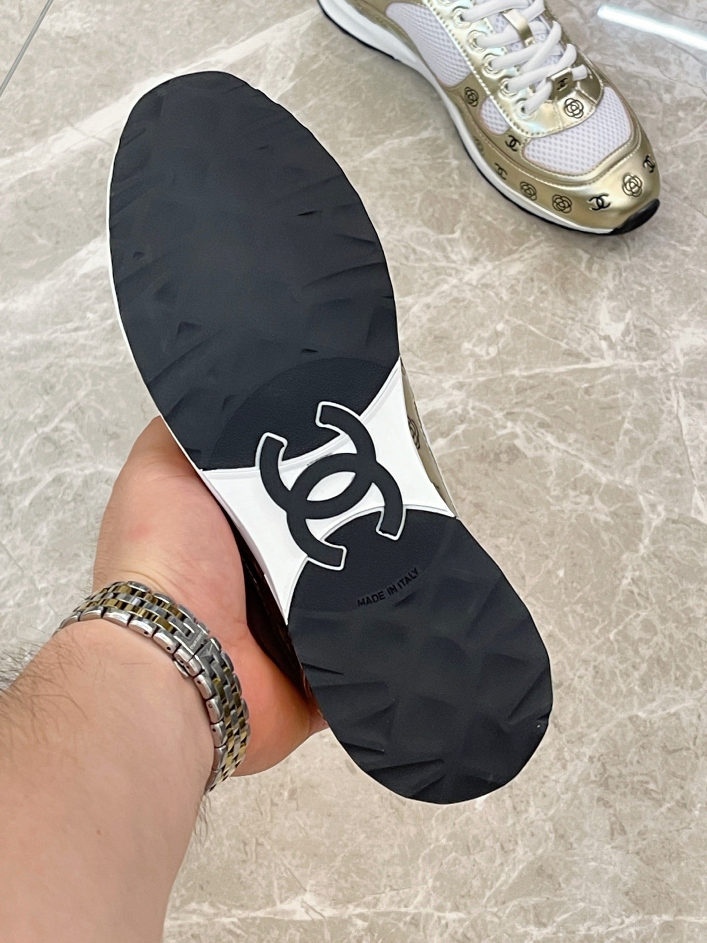 Unisex sneaker outsole, black rubber with white logo and traction tread