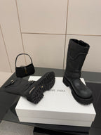 Balenciaga women's black boots with wraparound straps and rugged tread sole