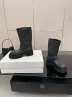 Balenciaga women's black mid-calf boots with side buckles and textured rugged sole