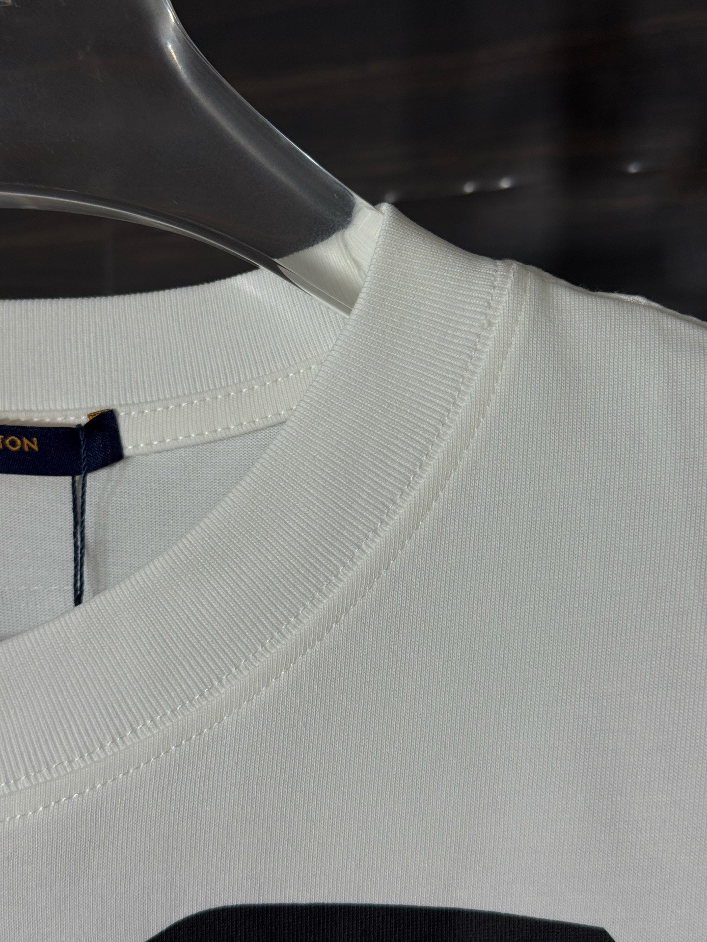 White crewneck T-shirt with ribbed collar and partial face graphic